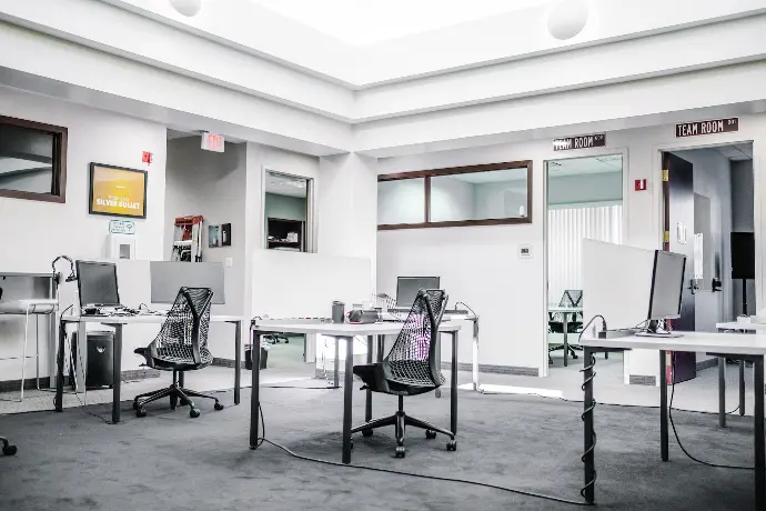 black metal chairs and table near white wall